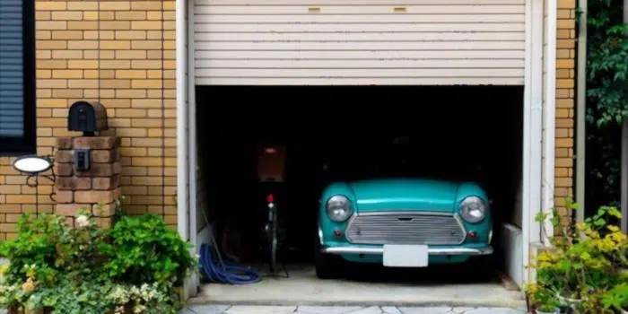 Darkened garage interior with one exterior opening left visible