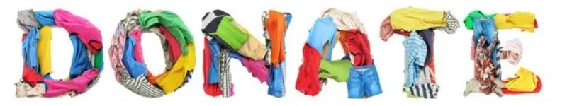 Folded clothing arranged to spell the word donate