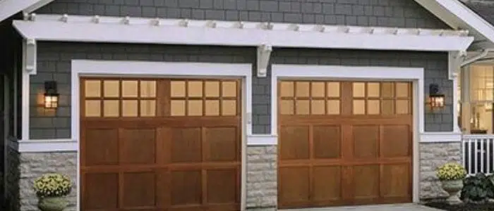 Wide wood Craftsman garage door with windows