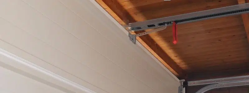 Daylight visible through a gap at the top of a closed garage door
