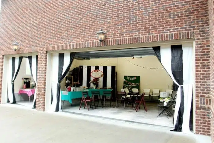 Black white and pink graduation party arranged in a garage