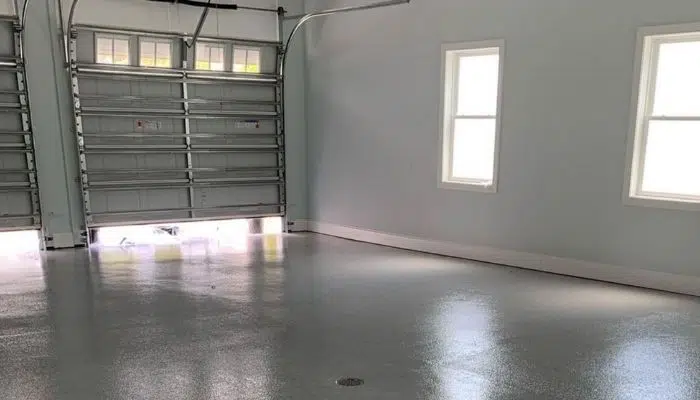 Garage with darker walls, white doors, and white trim