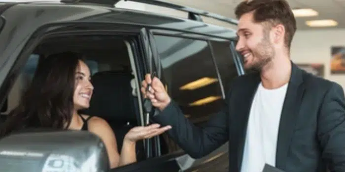 Seller handing vehicle keys to a new owner