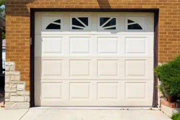 Single-car traditional garage door with windows