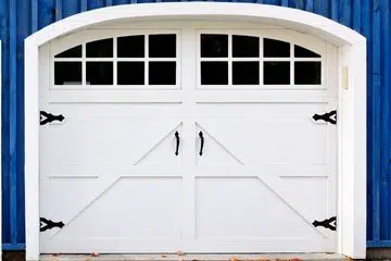 White single-car carriage-style garage door with windows