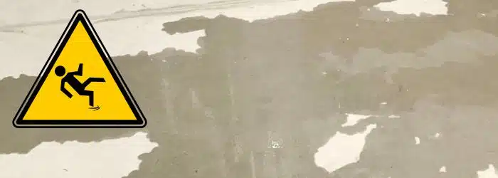 Wet concrete floor with a caution sign