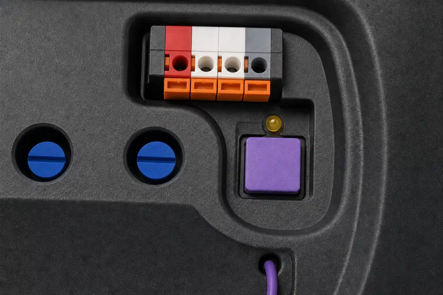 Illustrated close-up of a purple garage door opener LEARN button